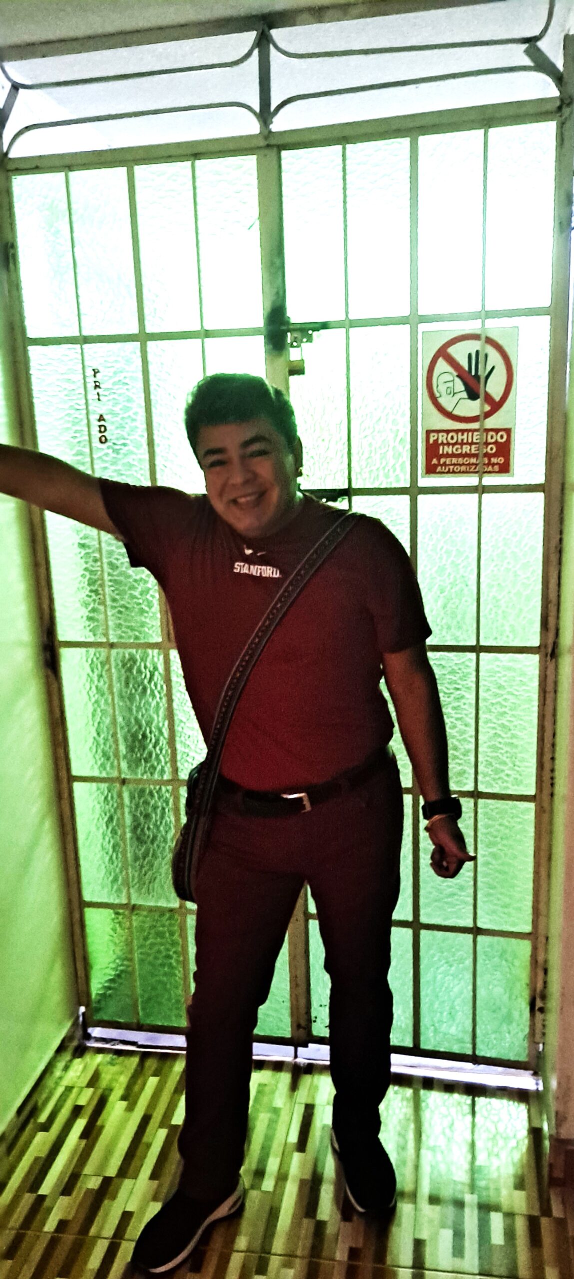 Photo of Daniel standing in front of the locked door to our apartment.
