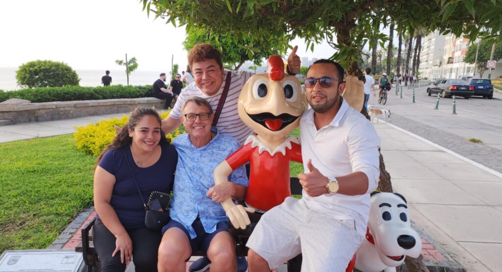 Photo of us sitting next to a statue of Condorito in Barranco